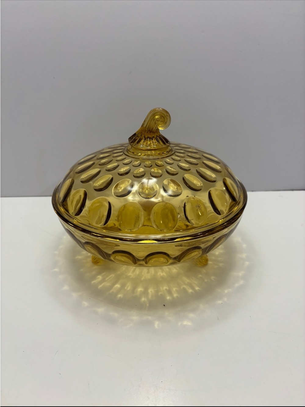 vintage honey amber thumbprint footed glass candy dish with a lid